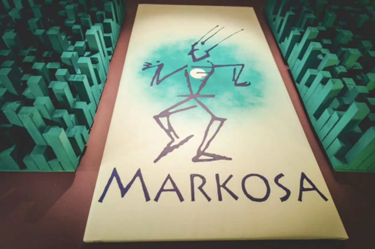 The Markosa logo banner surrounded by teal acoustic diffusers